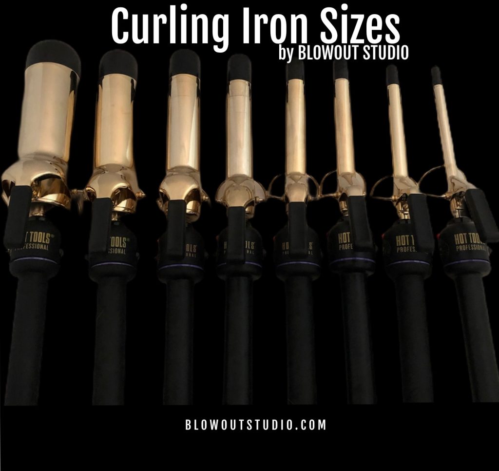 different sized curling irons on black background